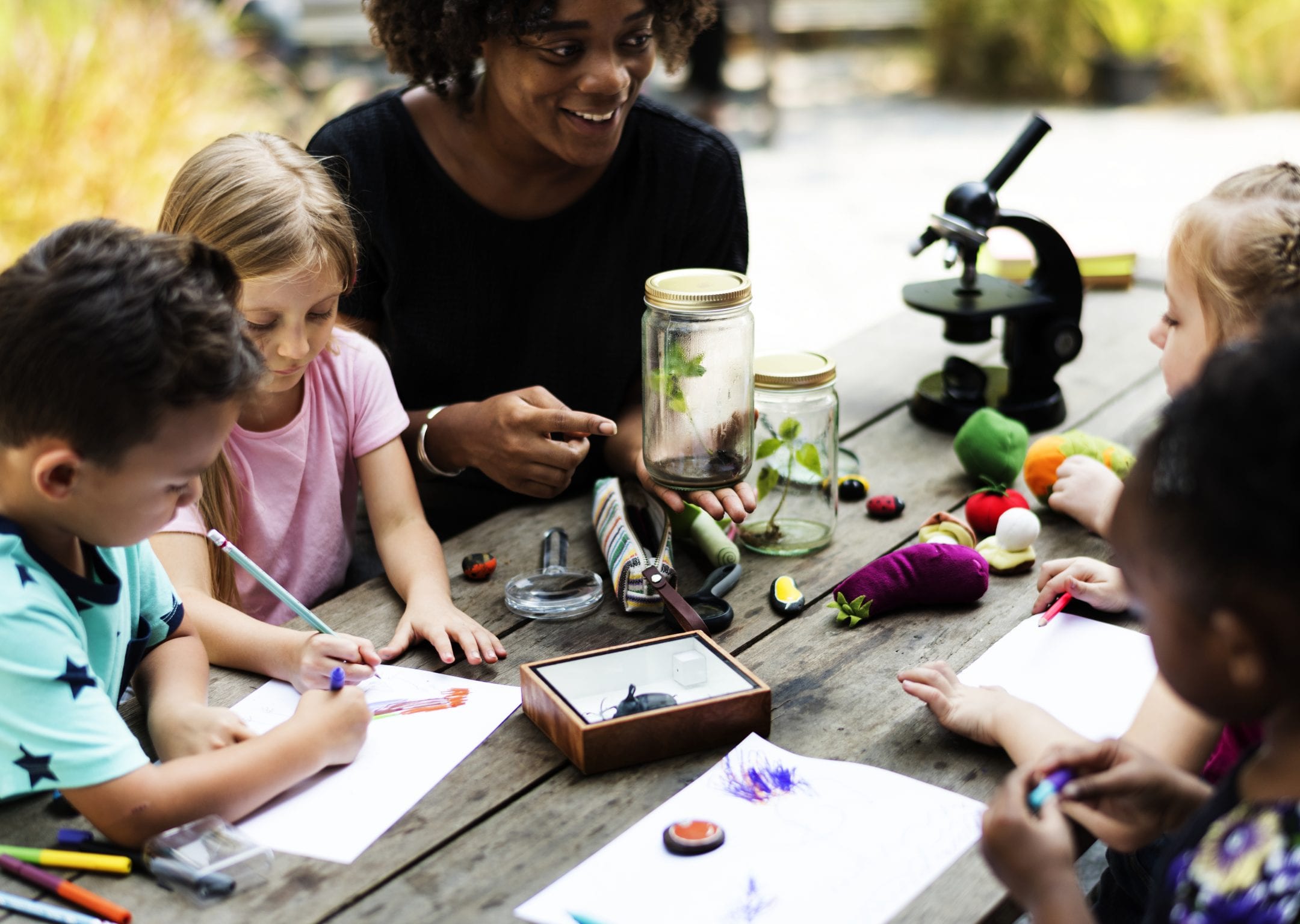 Young students examine and draw natural objects